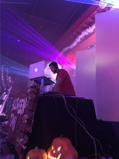 Professional DJ with laser show in the background