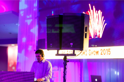 Professional DJ onstage behind speakers